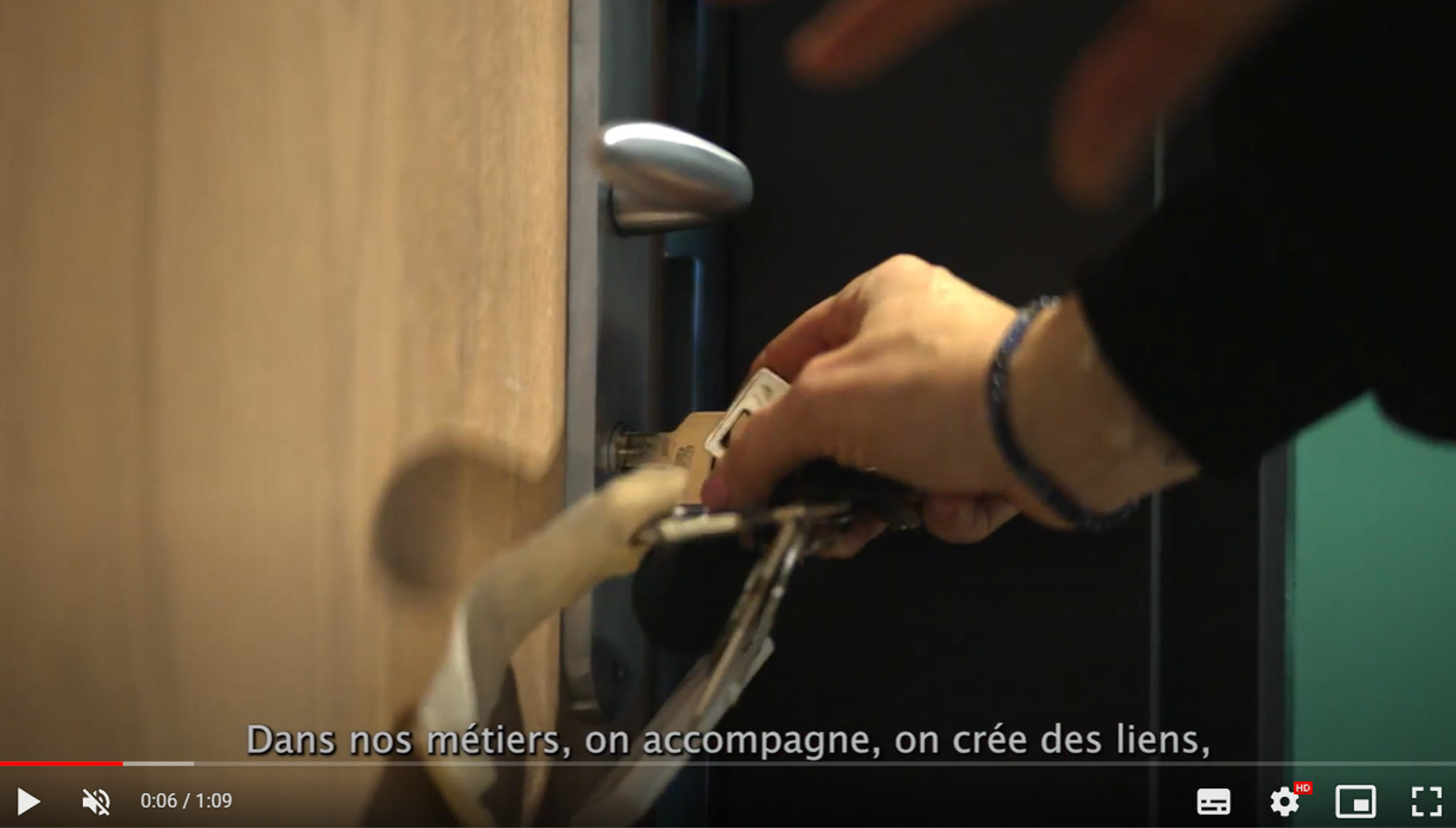 Une main tourne la clé dans la serrure d'une porte